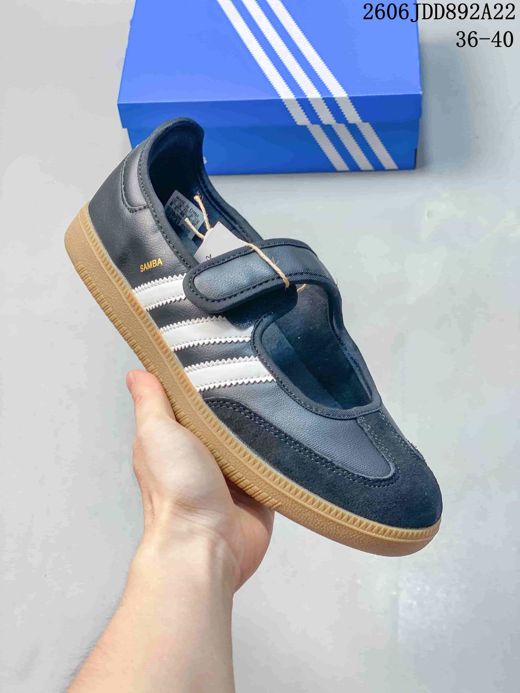 Angled view of a black adidas Samba Jane sneaker with white stripes and an instep strap.