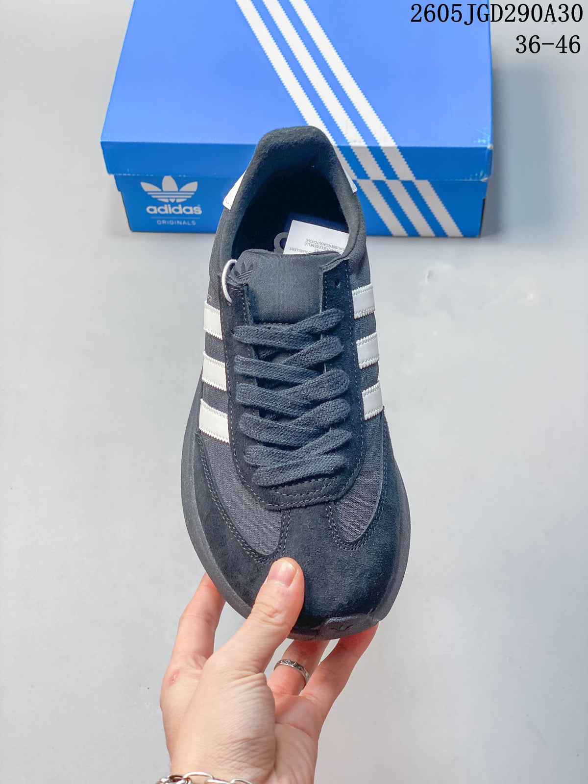 Front view of the lace-up dark SL 72 Pro sneaker with contrasting stripes.