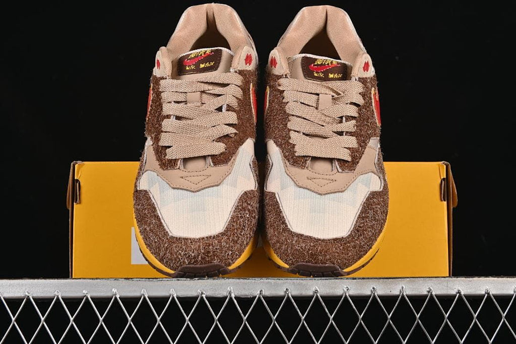 Front view of the pair resting on a yellow shoe box.