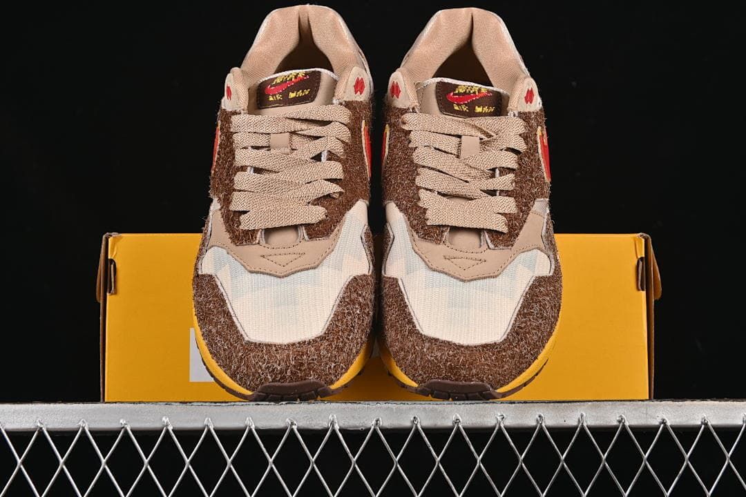 Front view of the pair resting on a yellow shoe box.