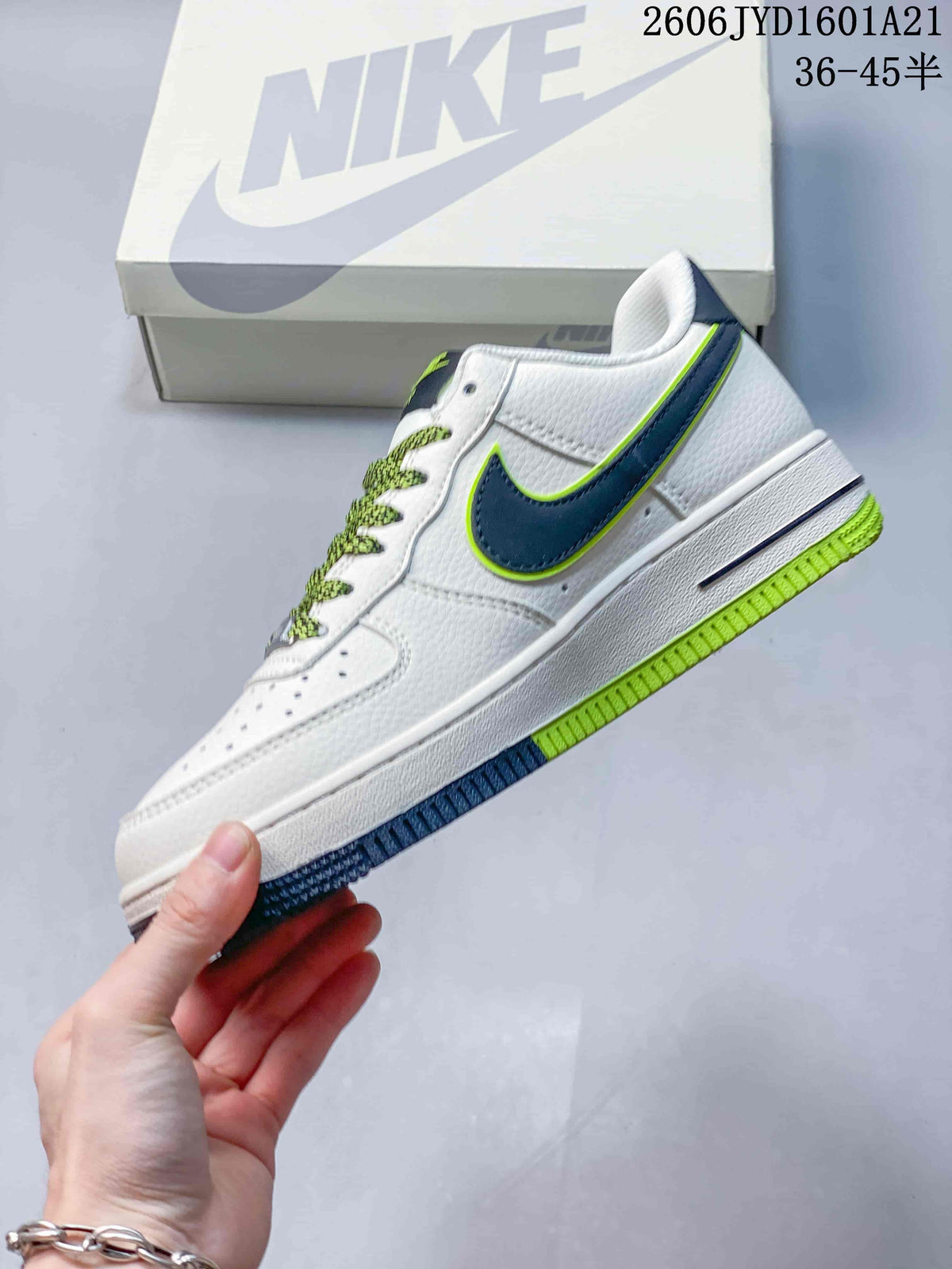 Side view of a white low-top sneaker with navy and lime accents