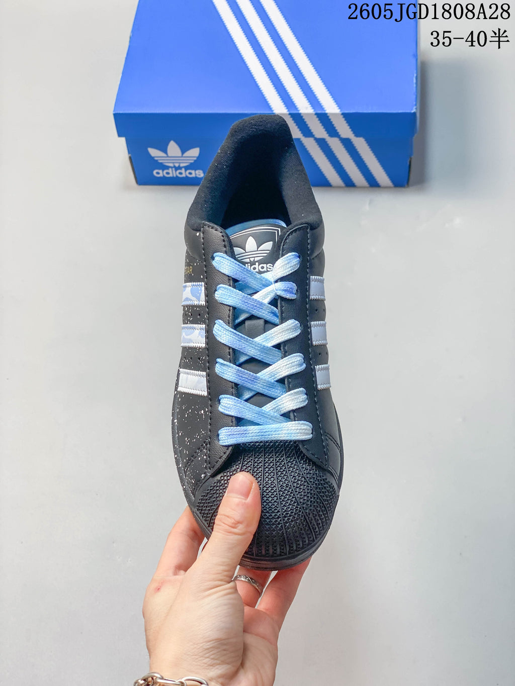 Front view showing the textured toe, light blue laces, and striped sides
