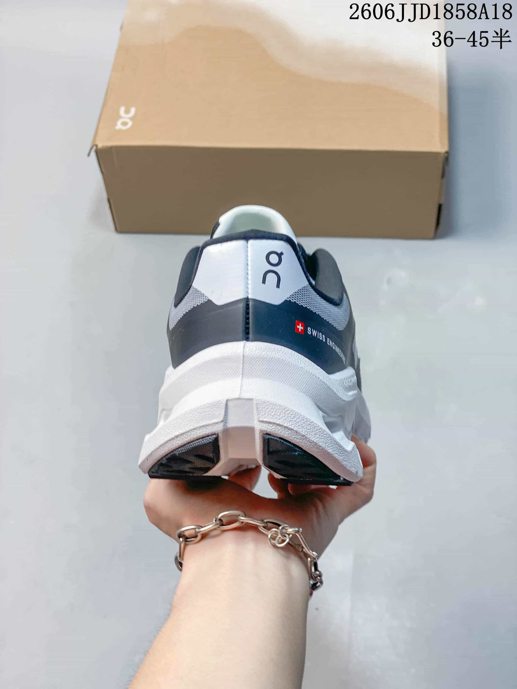 Rear view of the sneaker with a dark heel panel and white sole.