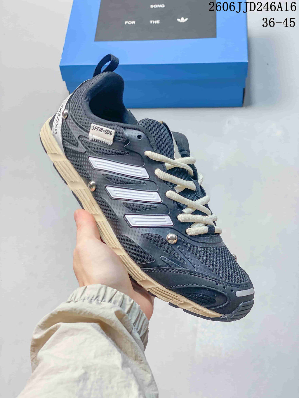 Side view of a dark gray Adizero PR SFTM-006 sneaker