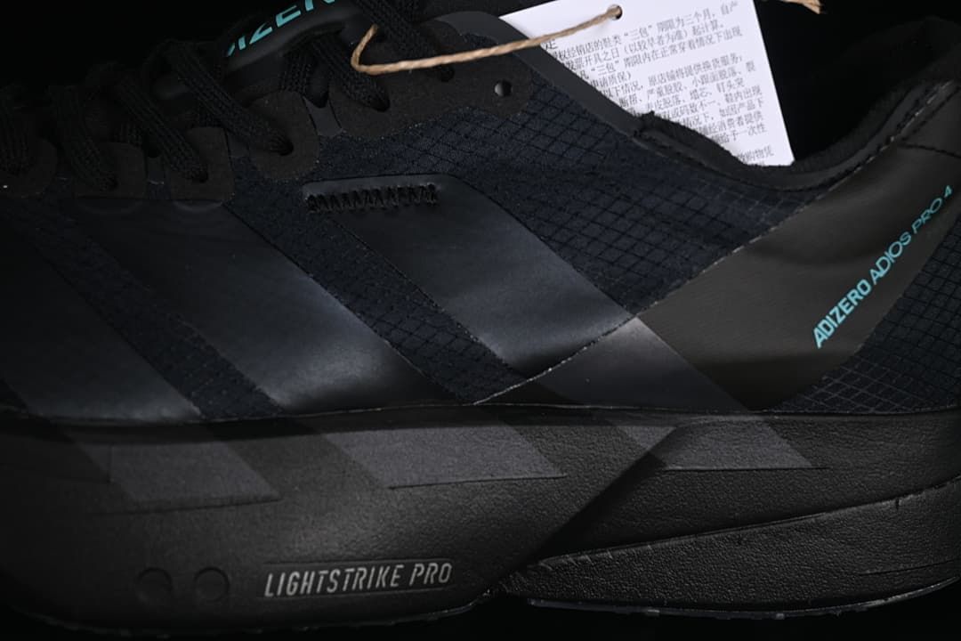 Side detail of the black upper, stripes, and midsole branding