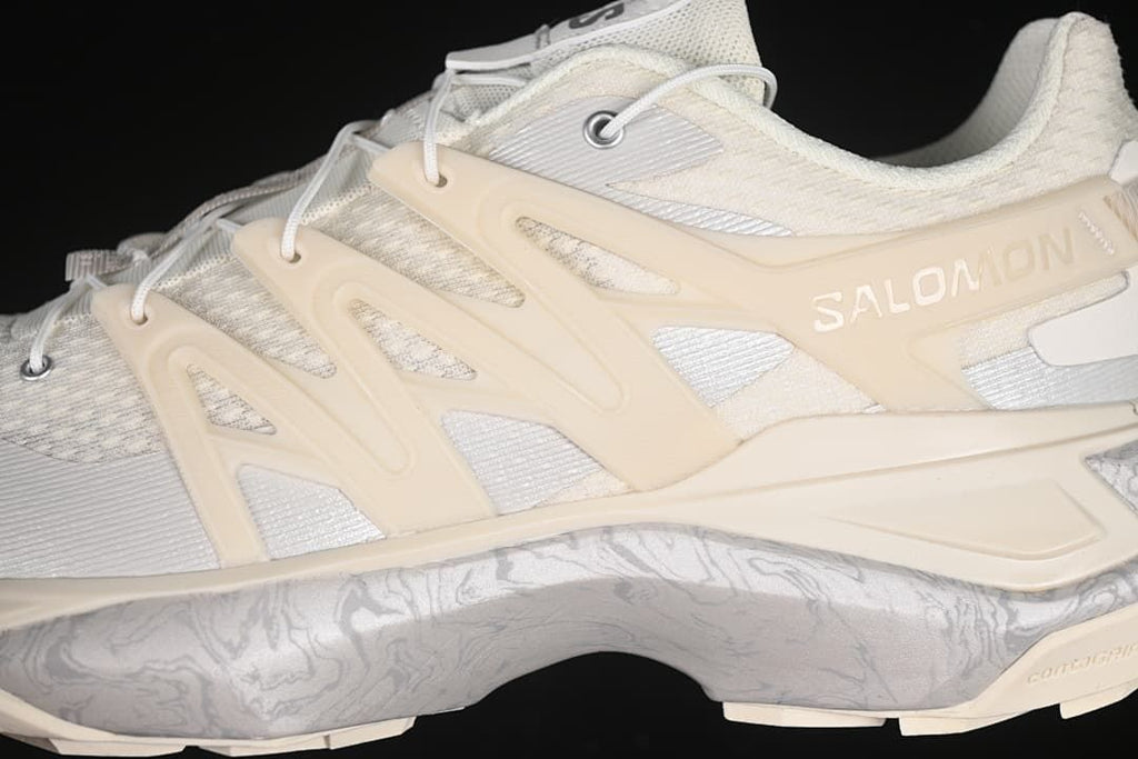 Close-up of the Salomon side frame, pale upper and patterned midsole.