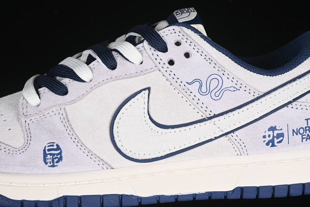 Close-up of the side panel, textured Swoosh, navy laces, and snake graphics.
