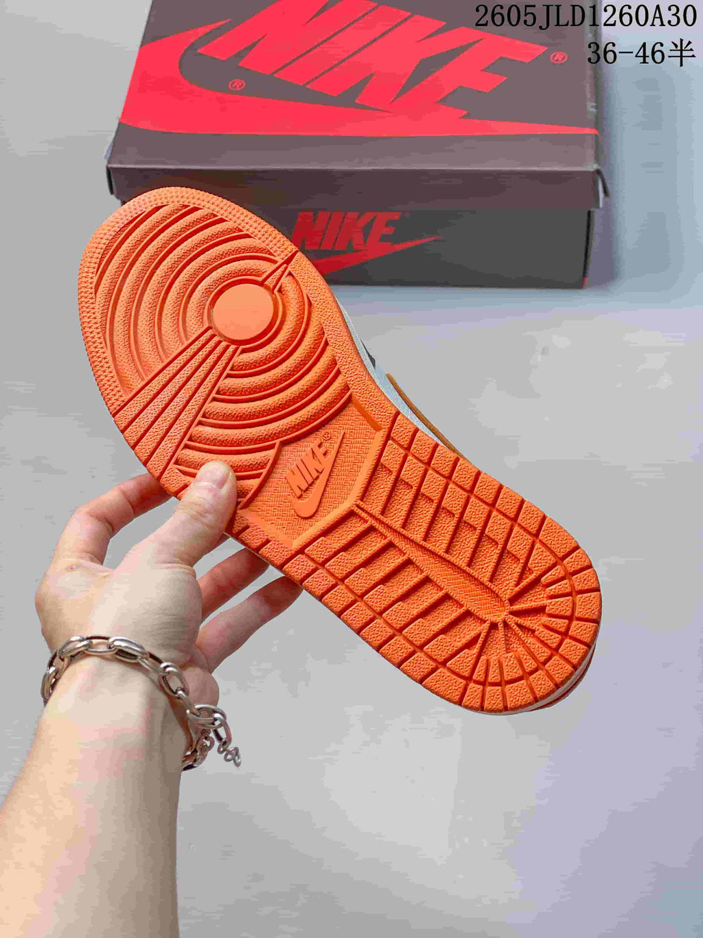 Close-up of the orange outsole and tread on a Jordan low-top sneaker