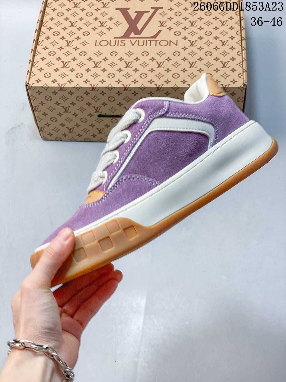 Side profile of the purple low-top sneaker with white trim and gum-colored outsole