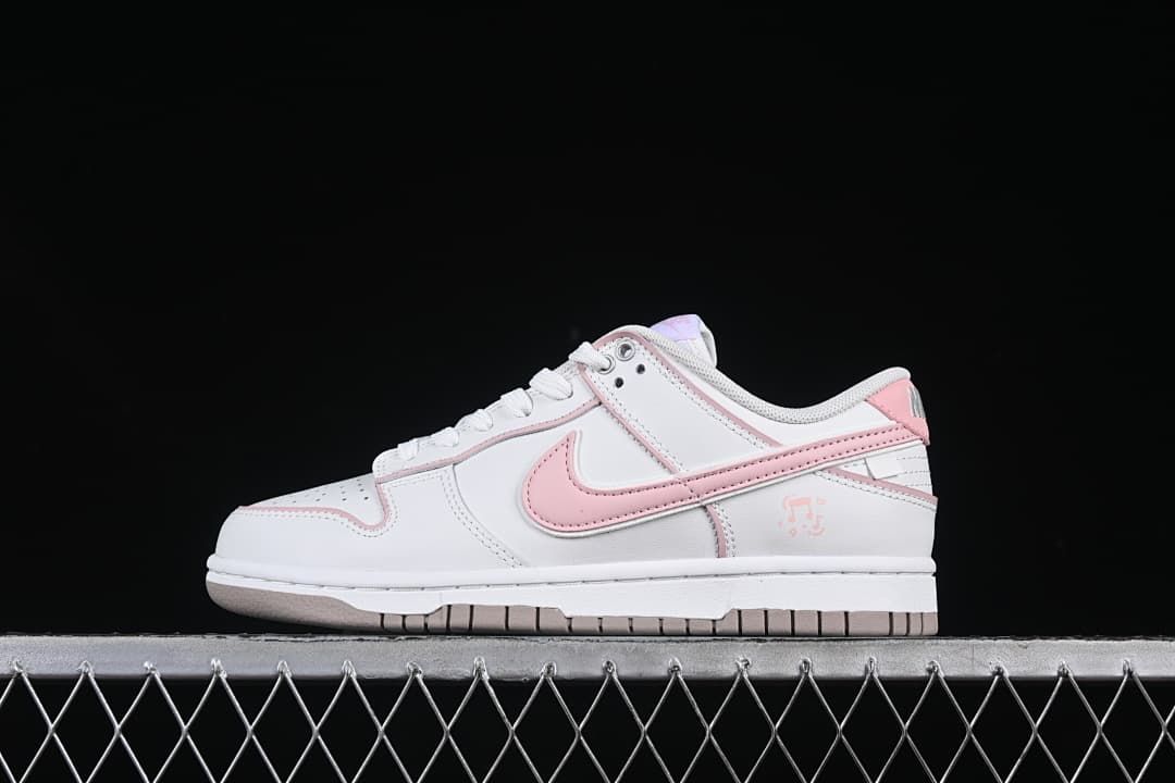 Side view of a white and pink Nike SB Dunk Low sneaker