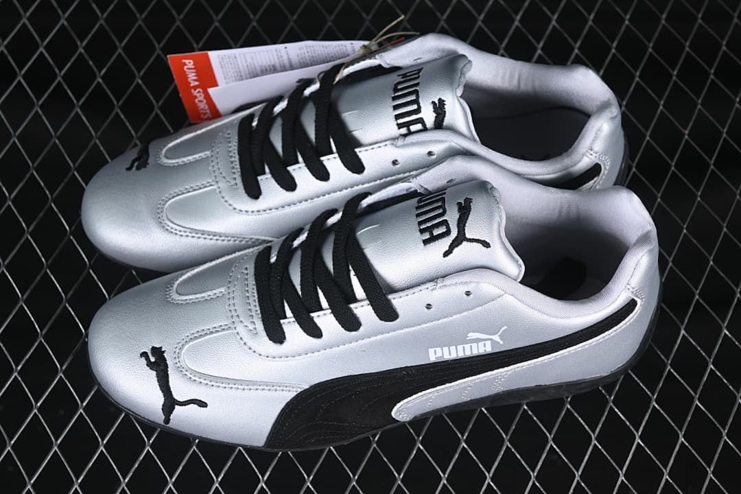 Pair of silver and black Puma Speedcat OG sneakers shown from above and the side.