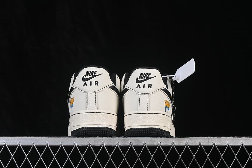 Rear view showing white heels, black accents, and small colorful side graphics