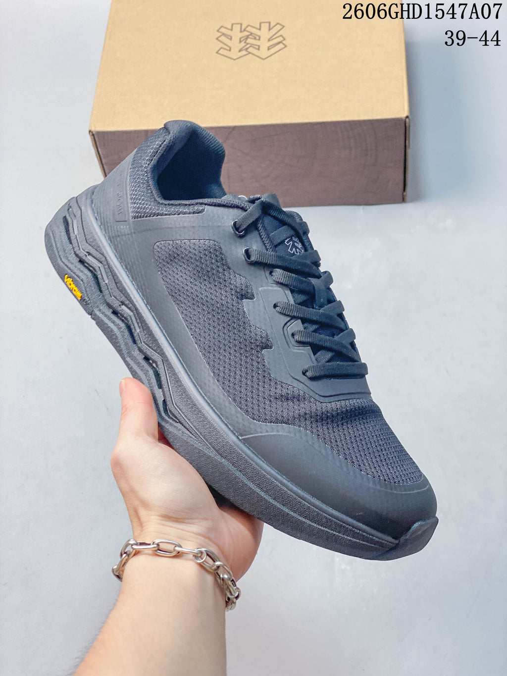 Angled side view of the dark gray Kolon Sport sneaker