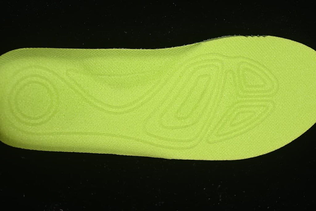 Close-up of the bright lime green patterned shoe insert.