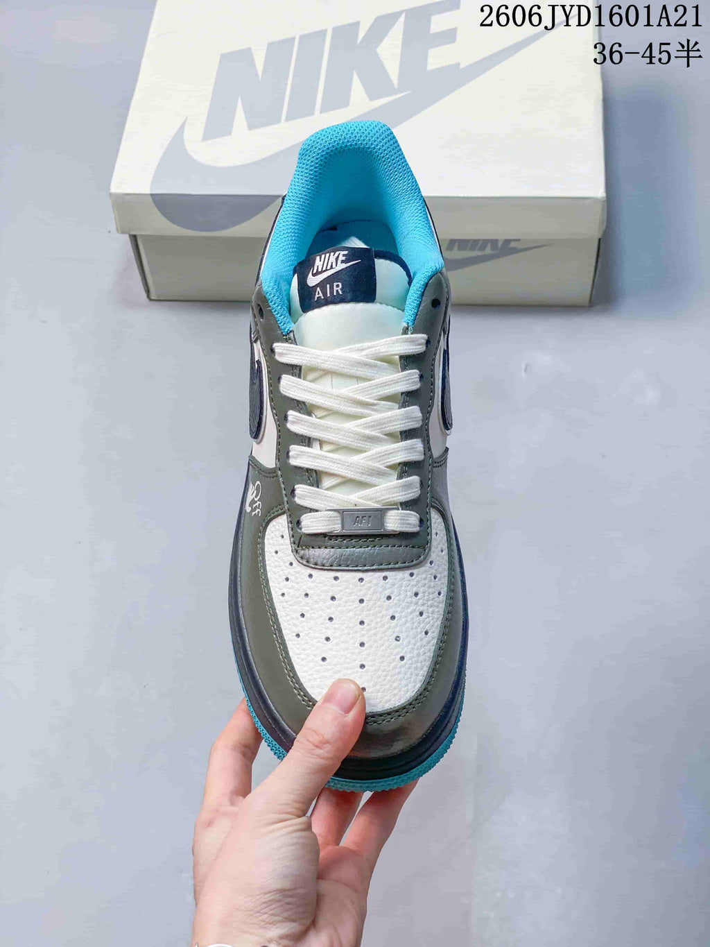 Top view showing white laces, a perforated white toe panel, and contrasting green and blue details.
