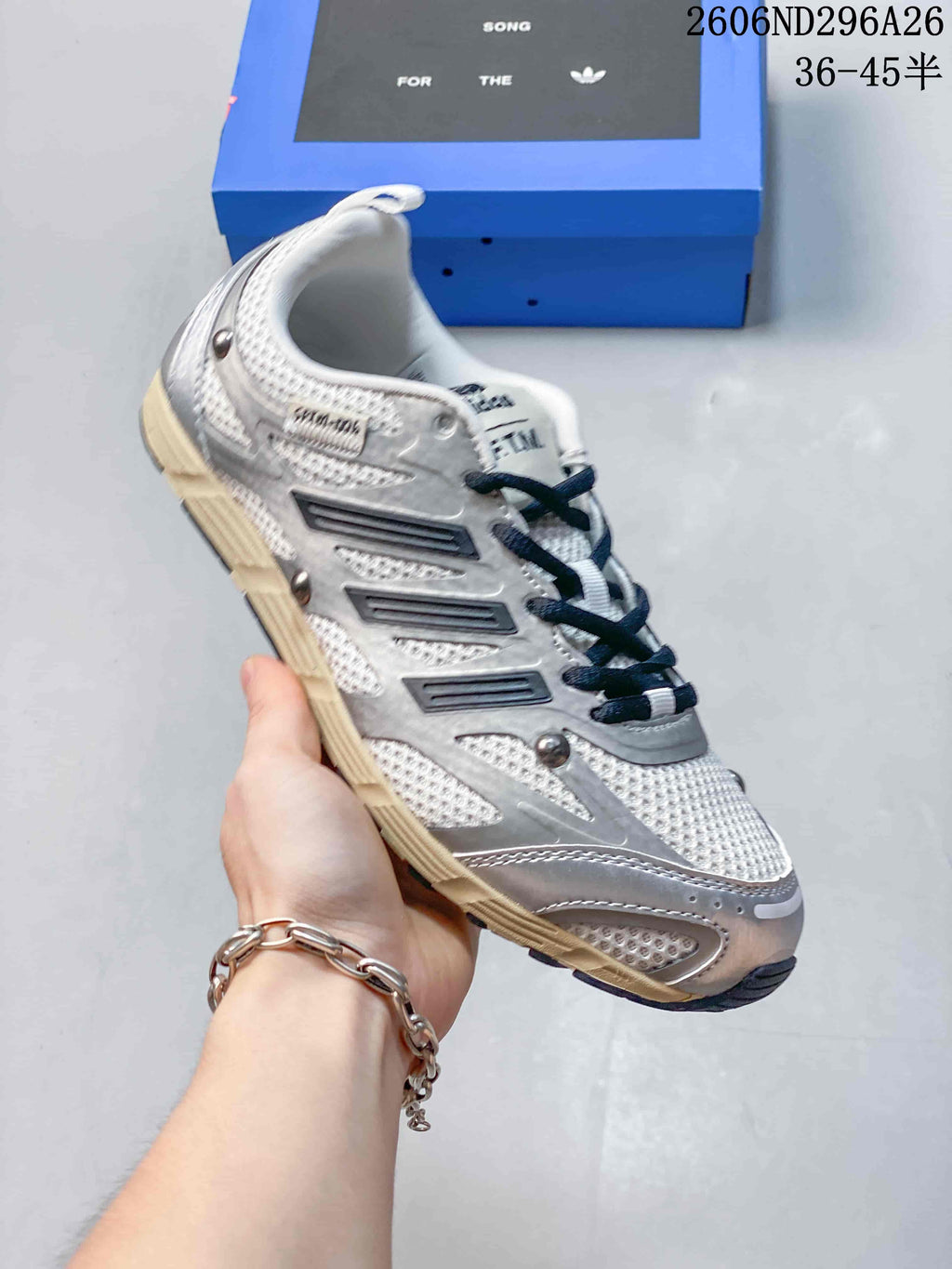 White and silver Adidas Originals SFTM-006 low-top sneaker with dark stripe details