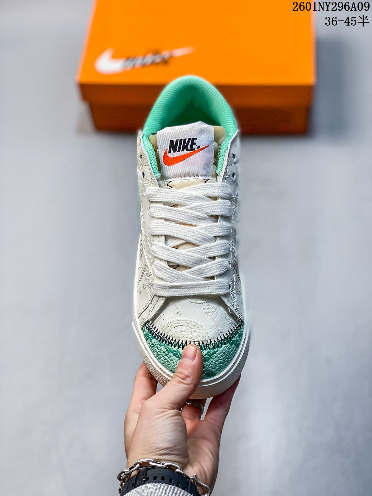 Front view showing white laces, green toe accents, and the tongue label.