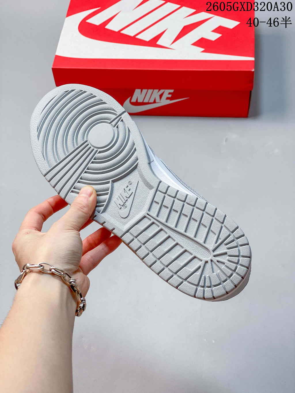 Close-up of the gray patterned outsole of a Nike Dunk sneaker.