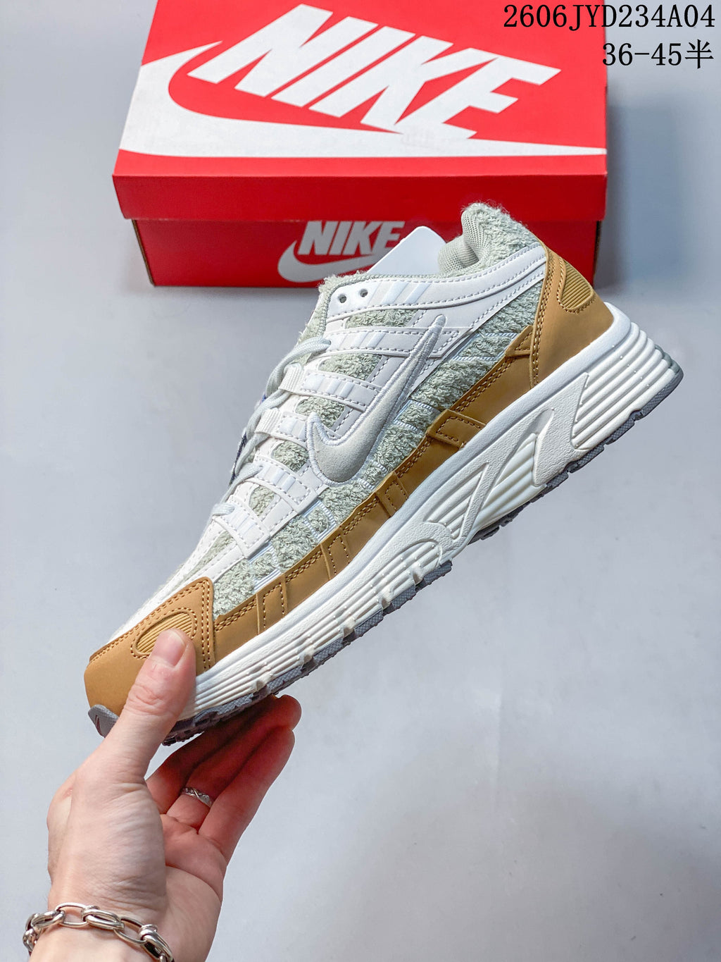 Side view of the Nike P-6000 with light green textured-looking panels, white overlays, and tan accents.