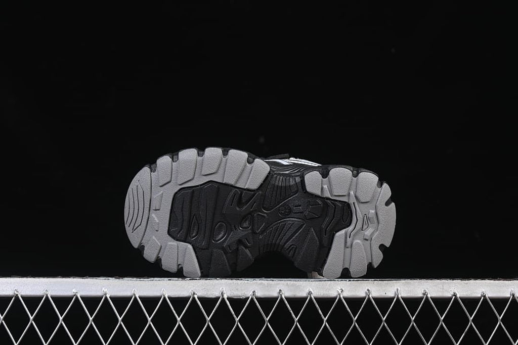 Underside of the sneaker showing the patterned outsole tread.