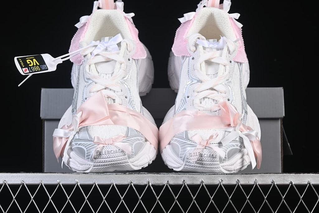 Front view of the pair showing the laces, ribbon details, and sculpted toes.