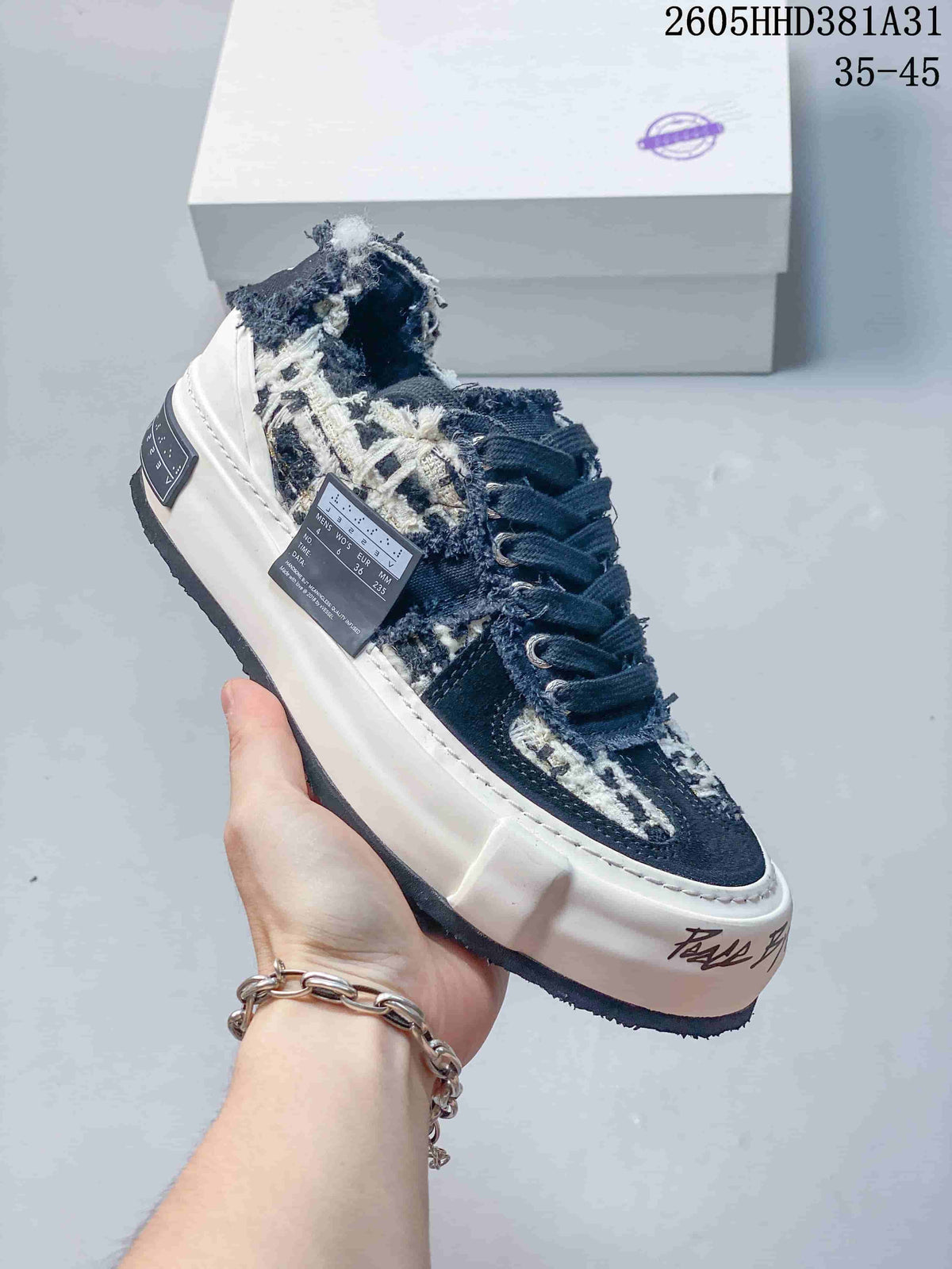 Angled side view showing the patterned upper, lace-up front, thick sole, and a size label.