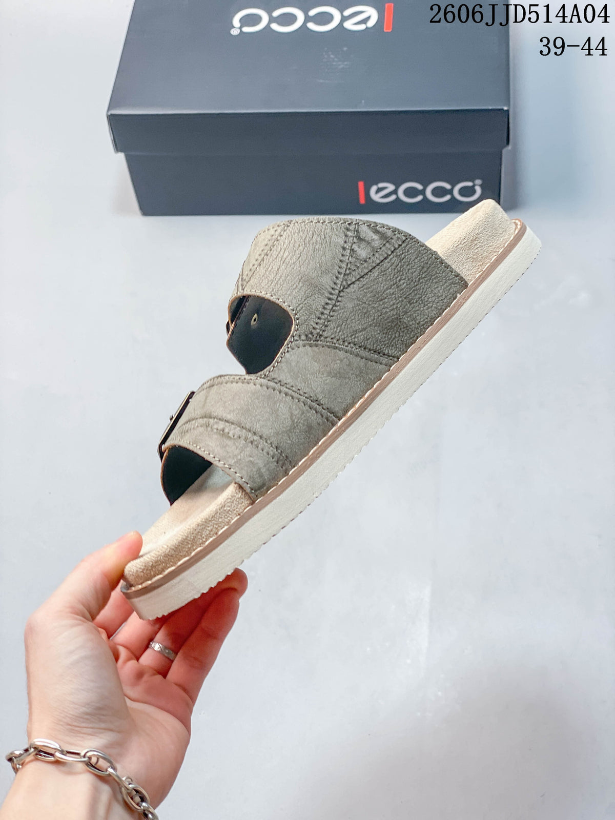 Side view of a taupe open-toe slide sandal with two buckle straps and a light-colored sole; image overlay shows 06JJD514A04 and sizes 39–44.