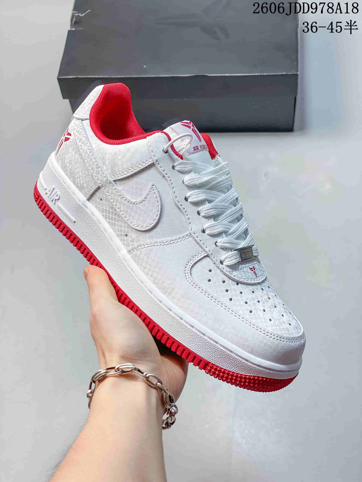 Close-up of the white sneaker with red lining and outsole accents