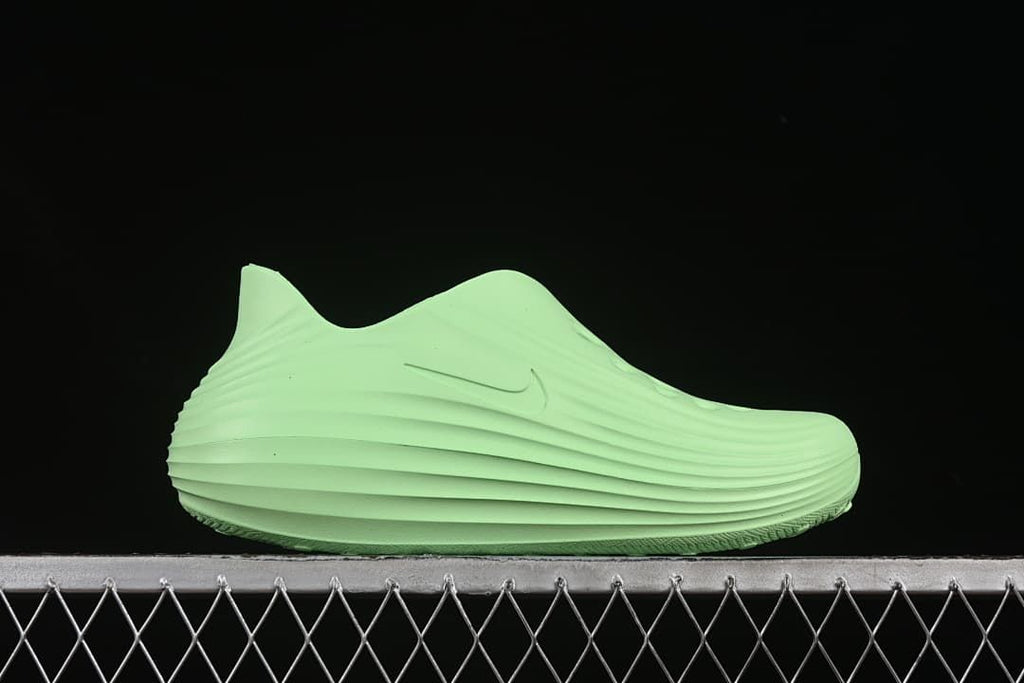 Side profile of a light green clog with a tonal Swoosh
