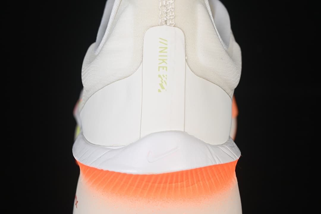 Rear view of the shoe with a padded collar and orange heel accent.