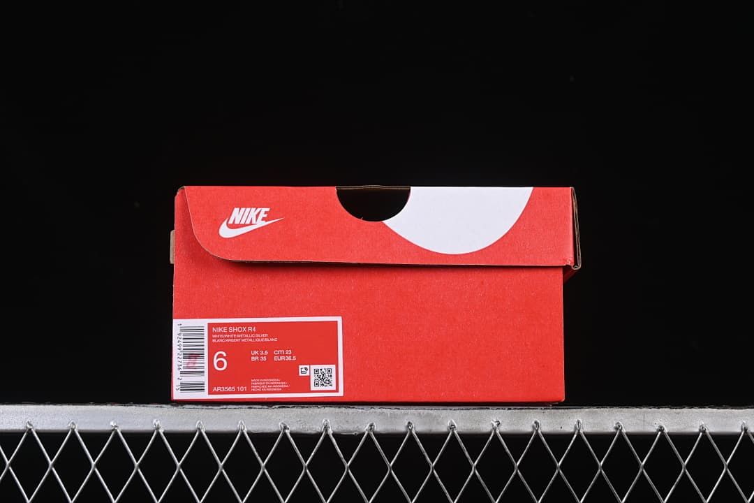 Red shoe box with a label identifying Nike Shox R4 and style code AR3565-101