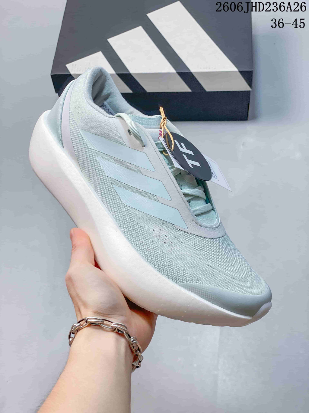 Close-up side view of a pale mint adidas ZENBOOST running shoe.