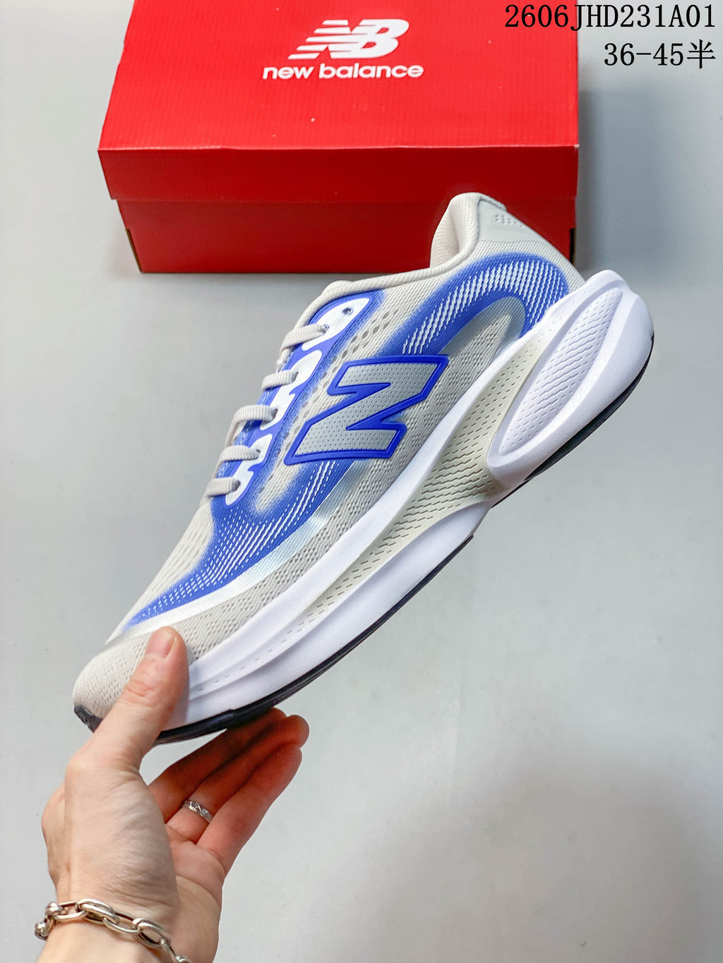 Side profile of the white and blue New Balance running shoe