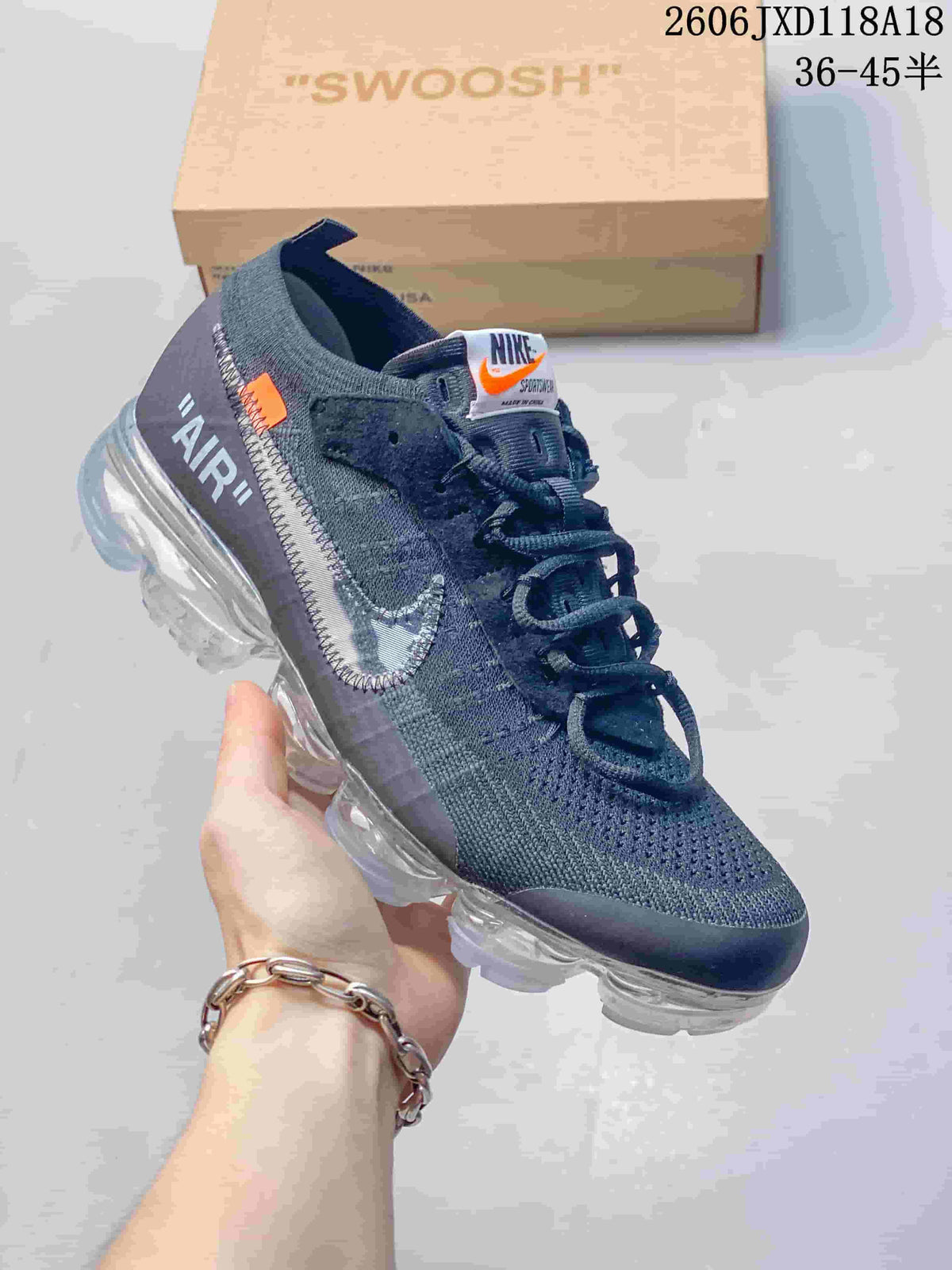 Dark gray Nike-style low-top sneaker shown from the side with knit-look upper and segmented sole.