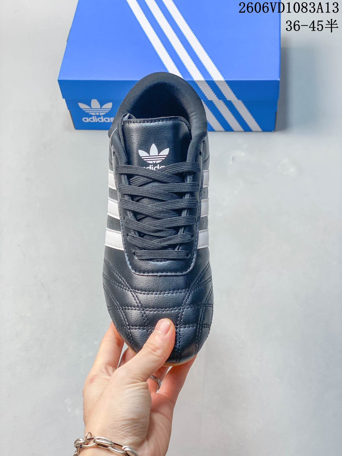 Top view of the navy Adidas Originals sneaker showing its laces and stitched toe
