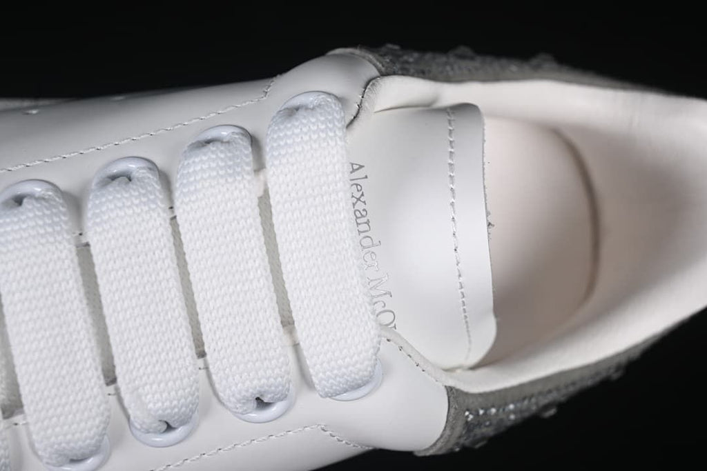 Top detail of the white laces and tongue with Alexander McQueen text.