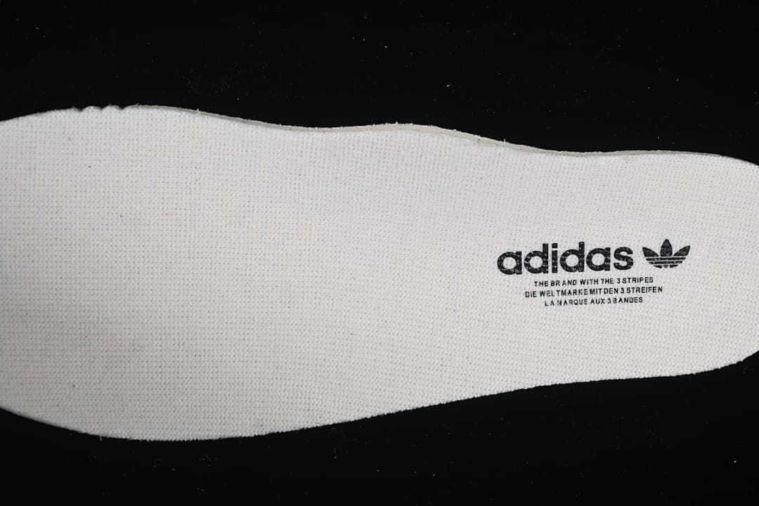 Close-up of a light-colored insole with adidas branding