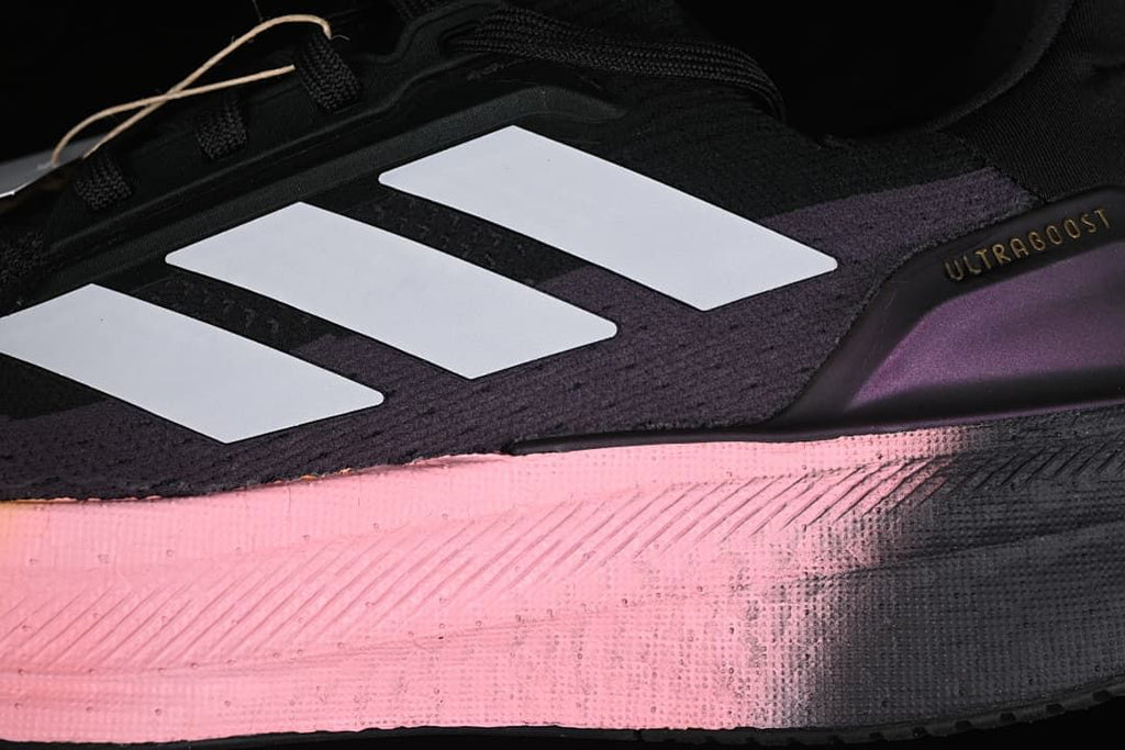 Close-up of the white side stripes, Ultraboost heel detail and gradient midsole.