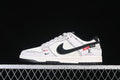 Side view of white and black low-top sneakers with patterned laces and graphic upper details