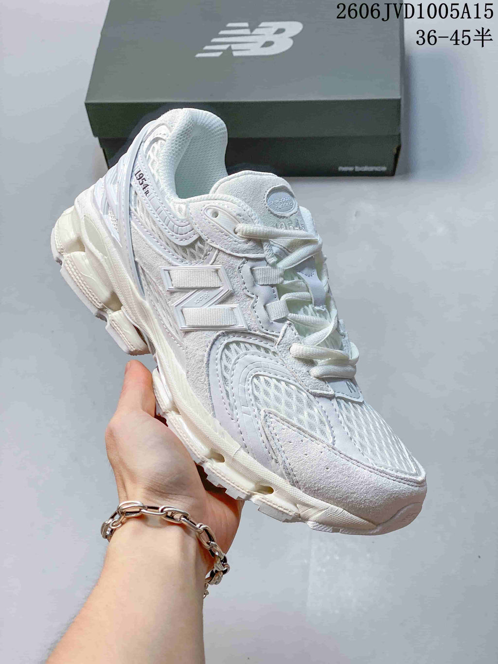 Angled side view of the white sneakers with layered details