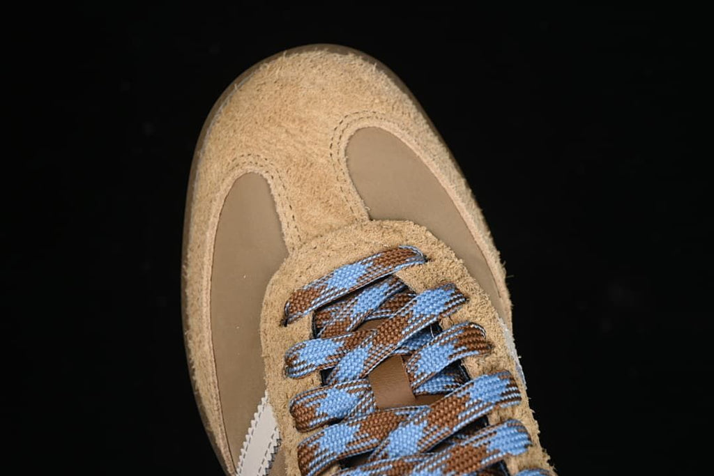Top view of the sneaker toe, textured tan overlays and patterned laces