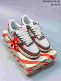 Pair of gray, off-white, and brown Nike Air Force 1 sneakers with embroidered detailing, red charm, and patterned box.