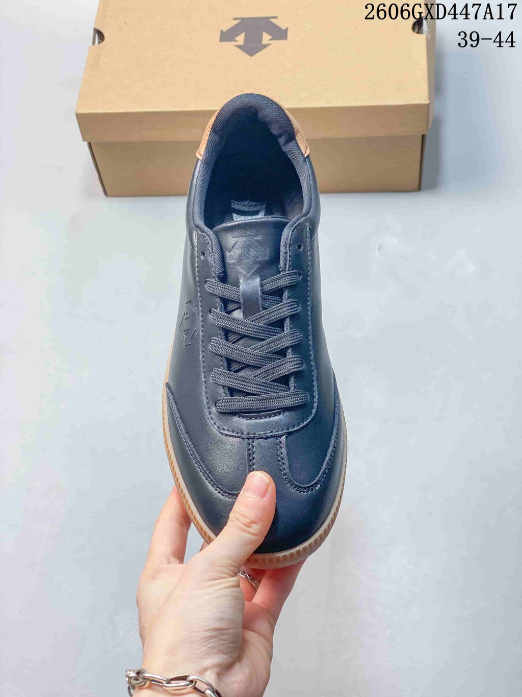 Top view of the navy lace-up sneaker showing its stitched toe overlay.