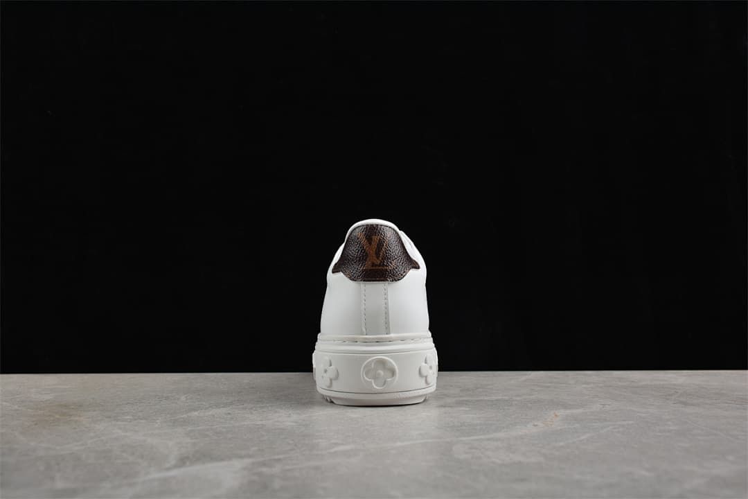 Rear view showing the brown heel panel and raised patterned sole