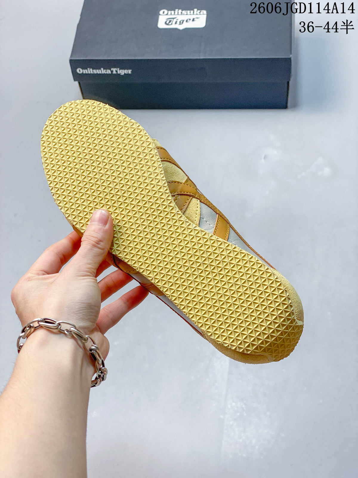 Close-up of the yellow-toned outsole showing its repeating geometric tread pattern