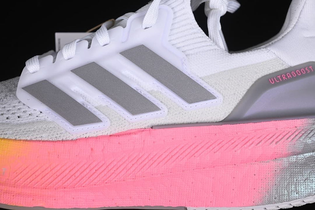 Close-up of the grey side stripes and pink midsole detail