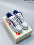 Pair of white, gray, blue, and red low-top sneakers displayed on a branded box