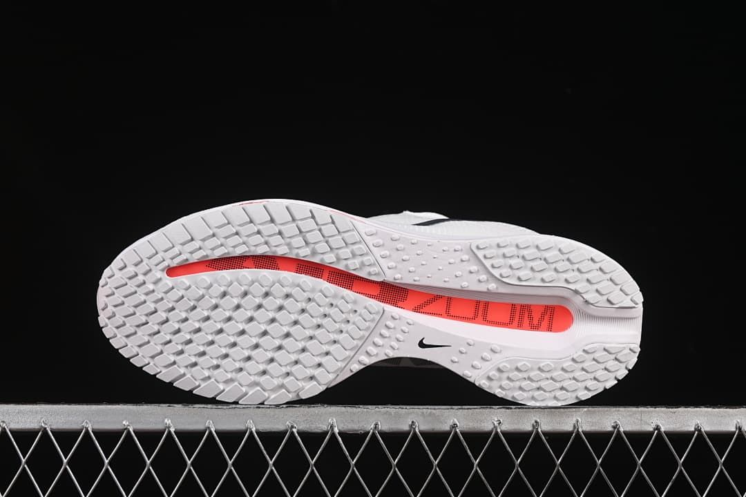 Outsole view showing patterned tread and a red central strip.