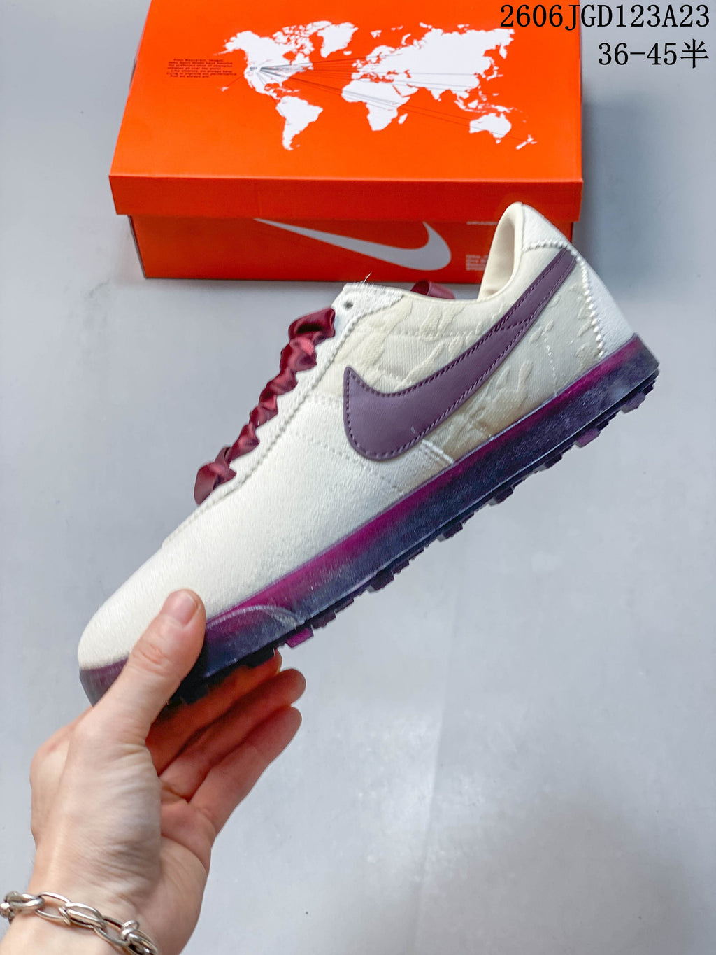 Side profile of the off-white sneaker with a plum Swoosh and plum-toned outsole