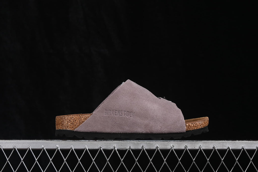 Outer side profile showing the lavender upper and embossed Birkenstock branding.